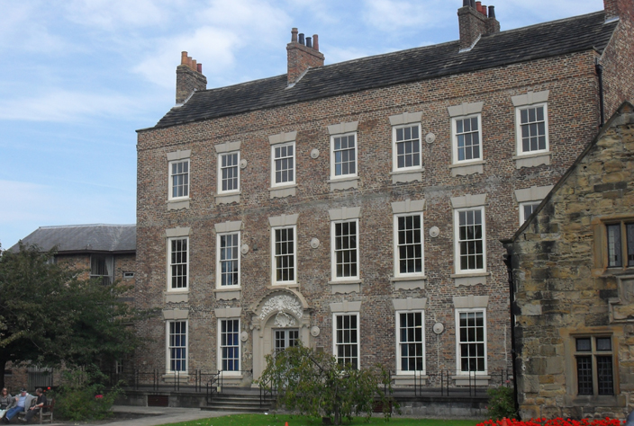 General view of the facade of Cosin's Hall, a typical Georgian Buildinga simple massive facade, and rows of rectangular windows. 